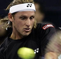 Argentina's David Nalbandian returns a ball from world number one, Switzerland's Roger Federer during the singles final for the Shanghai Tennis Masters Cup held at the Qi Zhong stadium in Shanghai, China, Sunday, Nov. 20, 2005.