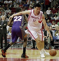 Houston Rockets center Yao Ming (11) of China, pushes past Phoenix Suns forward James Jones (22) in the fourth quarter in Houston, Wednesday Nov. 23, 2005. The Suns defeated the Rockets, 100-88. 