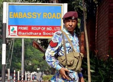 An armed Bangladeshi police officer stands guard at the diplomatic zone near the British High Commission in its capital Dhaka November 28, 2005.