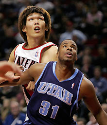 ortland Trail Blazers center Ha Seung-jin of South Korea (L) battles for rebound position with Utah Jazz forward Jarron Collins during the first quarter of their NBA game in Portland, Oregon December 4, 2005. 