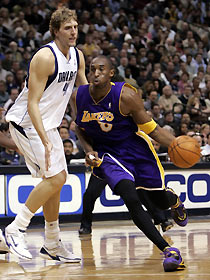 os Angeles Lakers forward Kobe Bryant (R) drives the lane past Dallas Mavericks forward Dirk Nowitzki (L) during second half action in Dallas, Texas, December 12, 2005. 