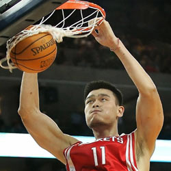 Houston Rockets Yao Ming dunks the ball in the first half of a NBA game against the Golden State Warriors in Oakland, California December 14, 2005.