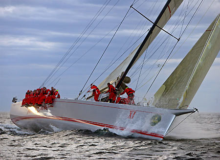 crew of Australian super-maxi Wild Oats sit on the side of the deck as they approach the finish line to take line honours for the Sydney-to-Hobart yacht race December 28, 2005.