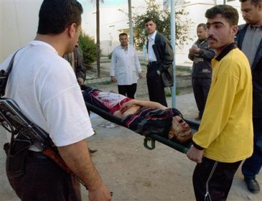 The body of victim from a bomb attack targeting a funeral service, arrives at the Muqdadiyah hospital morgue, Wednesday, Jan. 4, 2006, in Muqdadiyah, 90 kilometers (60 miles) north of Baghdad, Iraq.