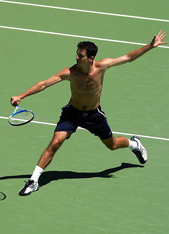 Britain's Tim Henman reaches for a backhand volley during a training session at Melbourne Park January 14, 2006. Henman is training in preparation for the Australian Open, the first Grand Slam tennis tournament of the year, starting January 16. [Reuters]