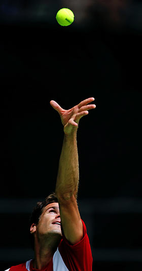 Tommy Haas of Germany serves to Richard Gasquet of France at the Australian Open tennis tournament in Melbourne January 17, 2006. [Reuters]