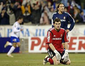 Real Madrid's goalkeeper Iker Casillas (bottom) and Michel Salgado react during their Spanish King Cup semi-final soccer match against Real Zaragoza at La Romareda Stadium in Zaragoza, Spain, February 8, 2006. 