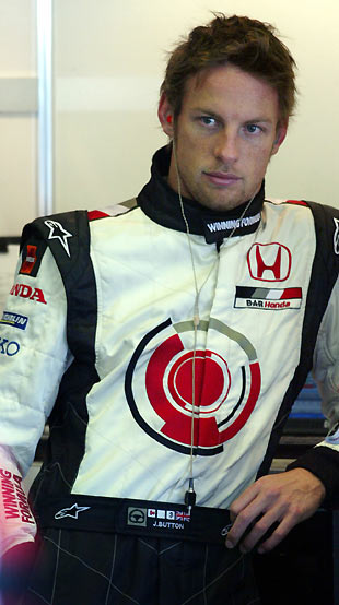 Honda's Formula One driver Jenson Button of United Kingdom takes a rest in the pits during a free practice session at the Jerez race track in southern Spain February 8, 2006.