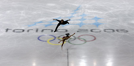 Figure skaters Rena Inoue (R) and partner John Baldwin from the U.S. perform their routine during a practice session at the Palavela figure skating venue ahead of the Torino 2006 Winter Olympic Games in Turin, Italy, February 8, 2006. A German court on Monday upheld an injunction allowing their coach Ingo Steuer, who was accused of having ties to the former East German secret police, to work at the Olympics in Turin. 