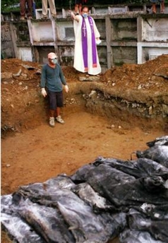 Standing in a light drizzle, the handful of mourners didn't know any of the 30 people laid side by side in a mass grave Sunday as workers began burying the few victims recovered since a mammoth mudslide wiped out this farming village. 