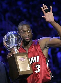 Miami Heat guard Dwyane Wade waves after being presented the trophy for winnng the NBA All-Star basketball Skills Challenge in Houston, Saturday, Feb 18, 2006.