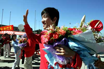 Chinese athletes return home