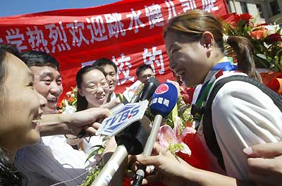 Chinese athletes return home