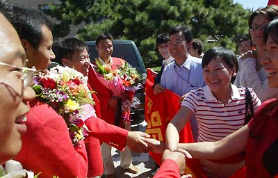 Chinese athletes return home