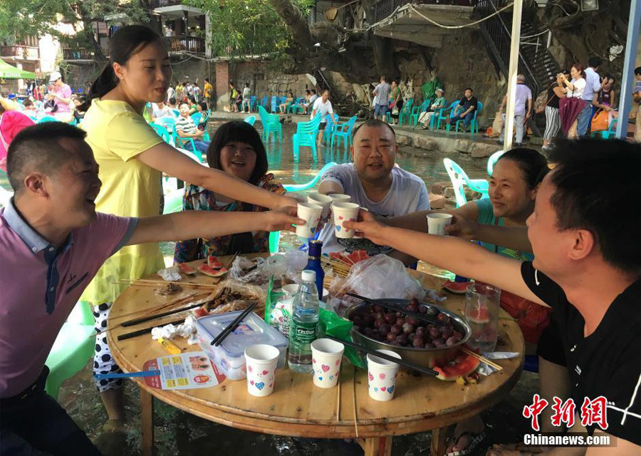 Playing Mahjong in the river: China's new way of tackling the summer heat