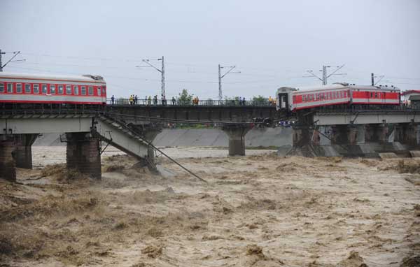 Train cars fall into river in SW China, no injuries