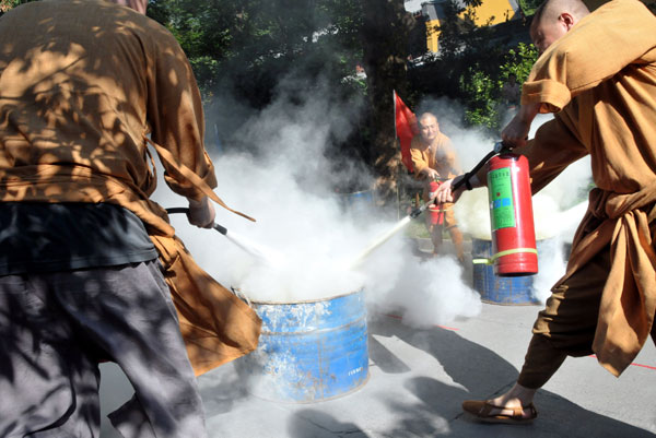 Monks test their firefighting skills