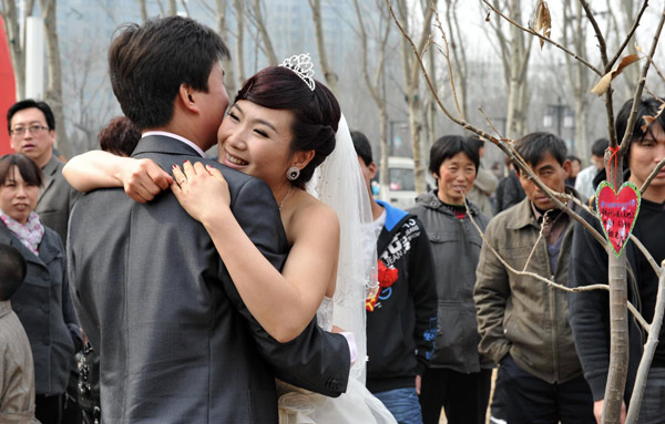 Newlyweds plant love trees on Arbor Day