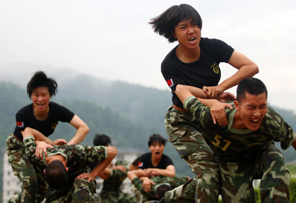 Armed policewomen train with soldiers