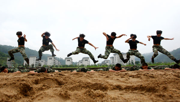 Armed policewomen train with soldiers