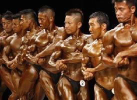 Bodybuilders prepare backstage before competition