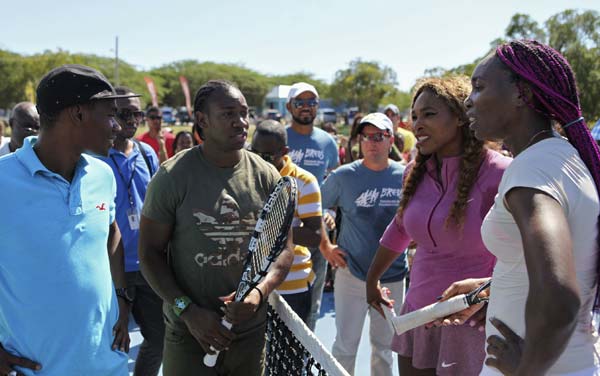 Williams sisters, Olympic sprinters join in tennis clinic