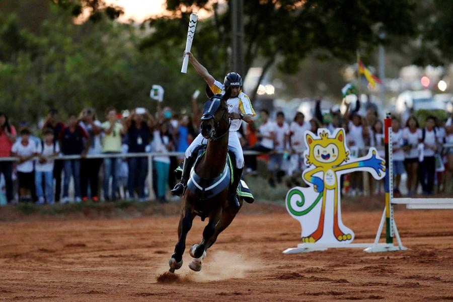 Olympic flame lands in Brazil for 94-day relay to Games