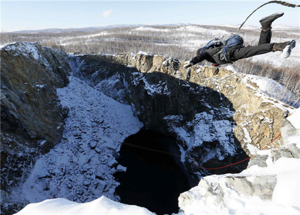 Rope-jumpers pictured leaping into crater